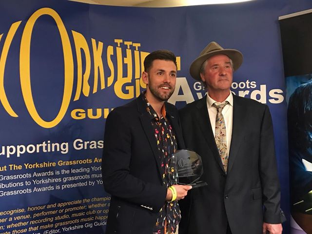 Ryan Swain receiving his award from Yorkshire Gig Guide