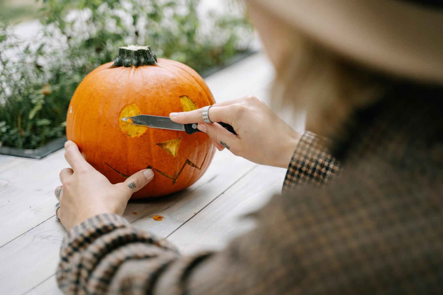 person carving a pumpkin